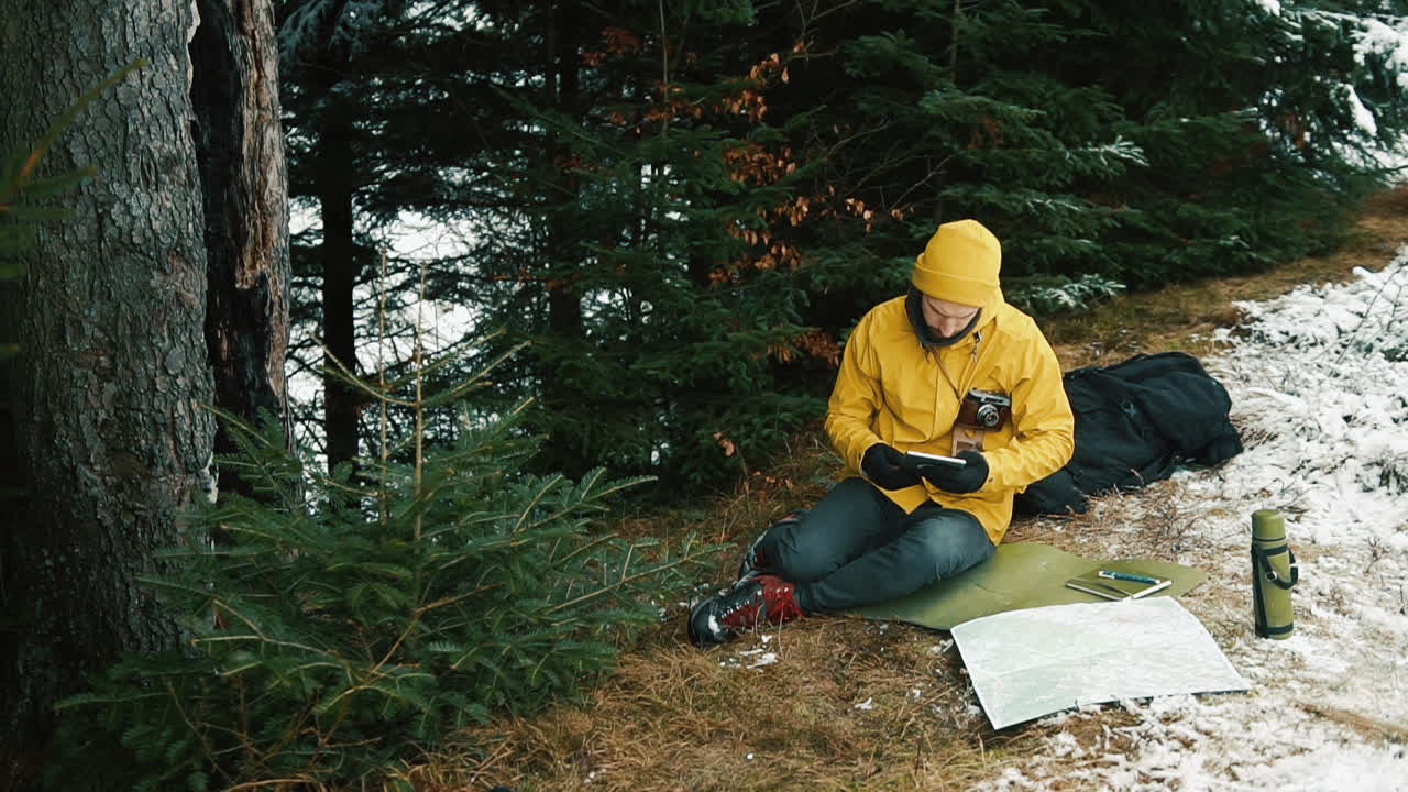 Hiker with Map and Tablet in Forest