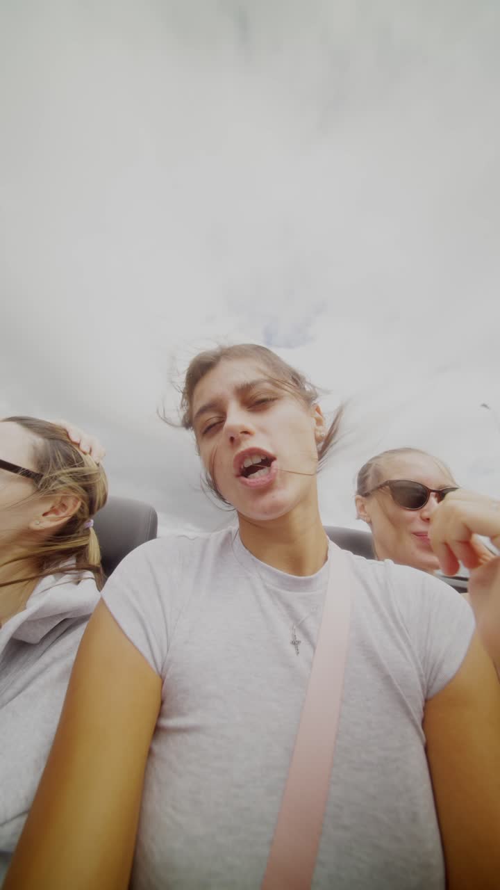 Three Friends Enjoying a Road Trip in a Convertible