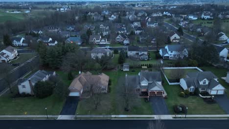 american housing homes in rural suburb area with driving white car on road