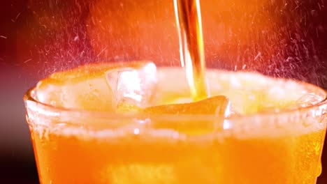 glass of soft drink. ice soft drink with splashing bubbles slow motion on a blurry light ,blurry background.