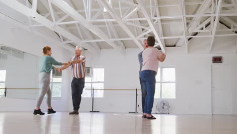 caucasian senior couples spending time together in a ballroom and dancing