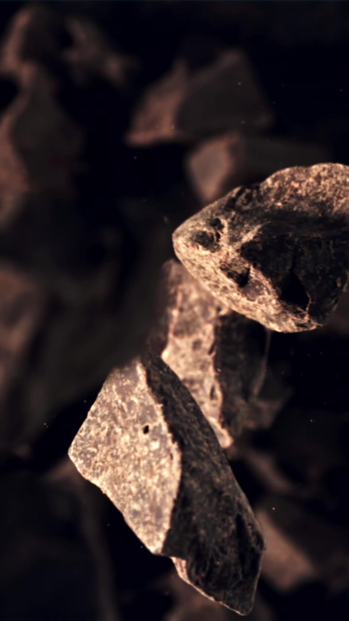 Delicious Chocolate Chunks Falling in Slow Motion on a Dark Background