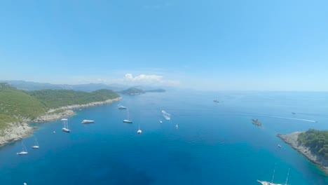 aerial drone footage of boats in the bay of beach sunj, lopud, croatia.