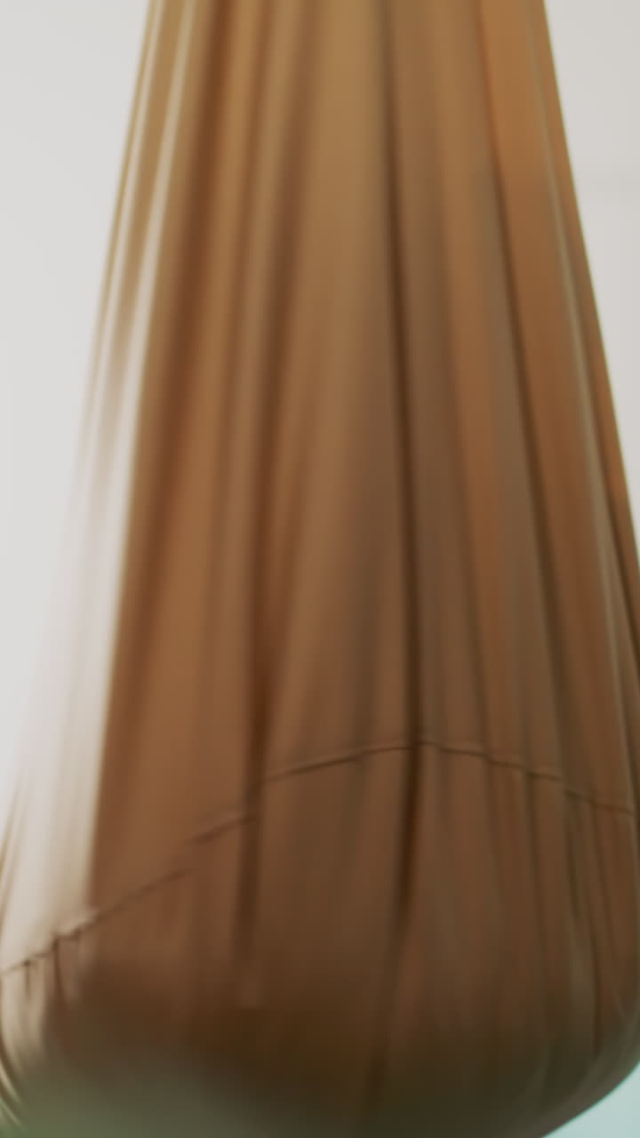 Emotional toddler boy plays and yells in hammock chair at home slow motion. Little kid happy of swinging textile cocoon with pillow in domestic gym