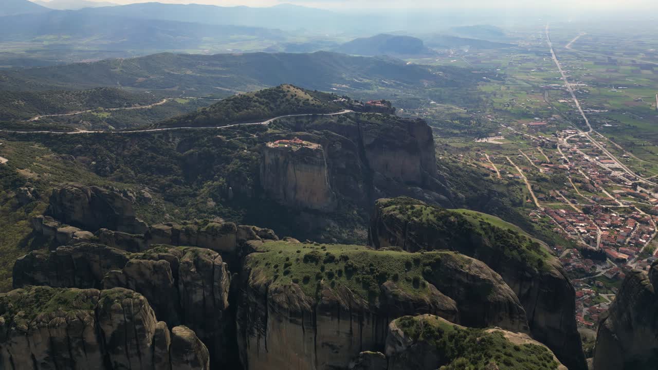 Aerial of cliff top Transfiguration Monastery in Meteora, Greece surrounded by cliffs