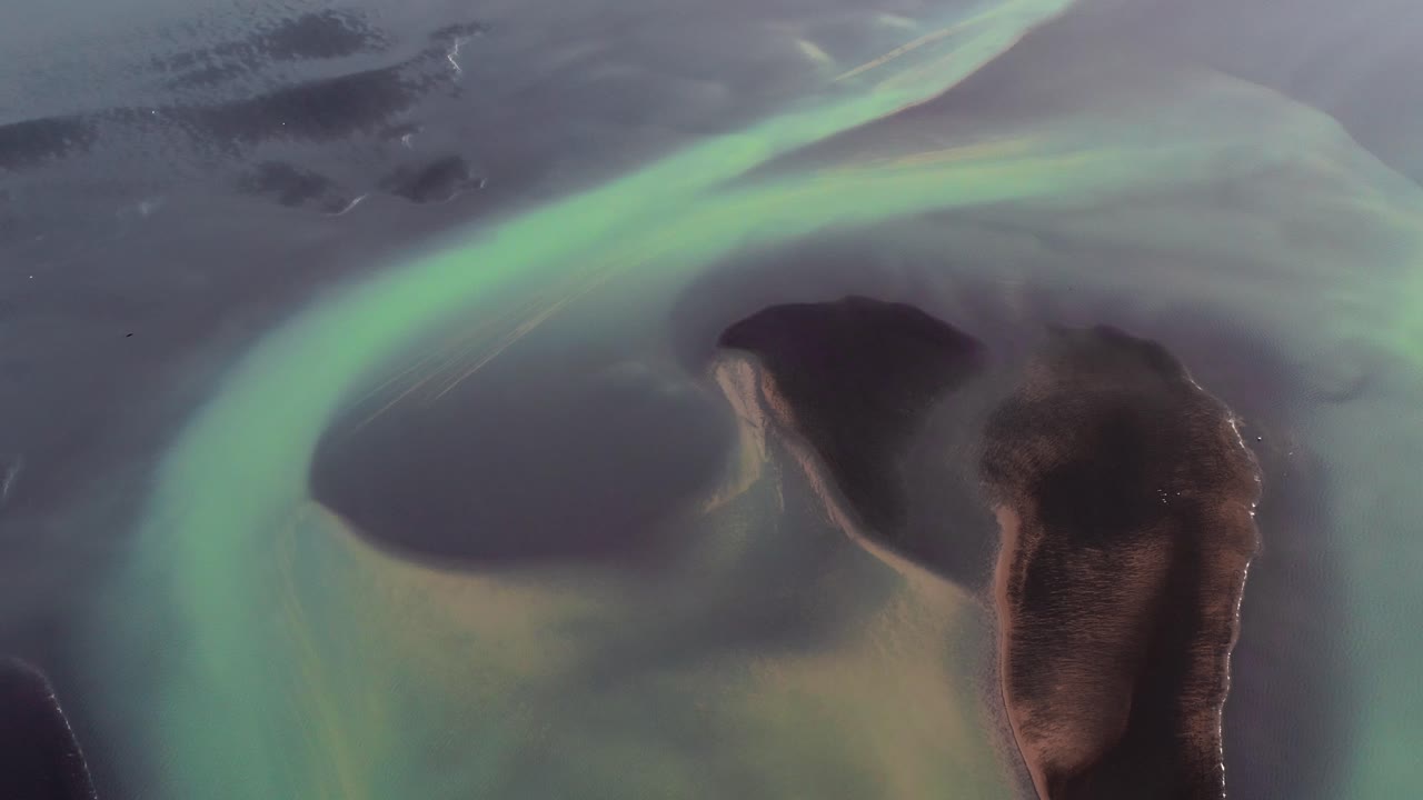 Drone flight over stunning Ölfusa River with dark and green pattern on surface