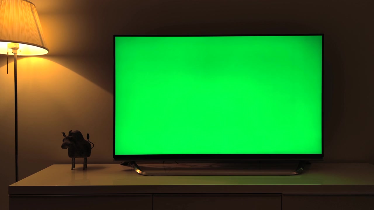 Television with Green Screen in Dimly Lit Living Room