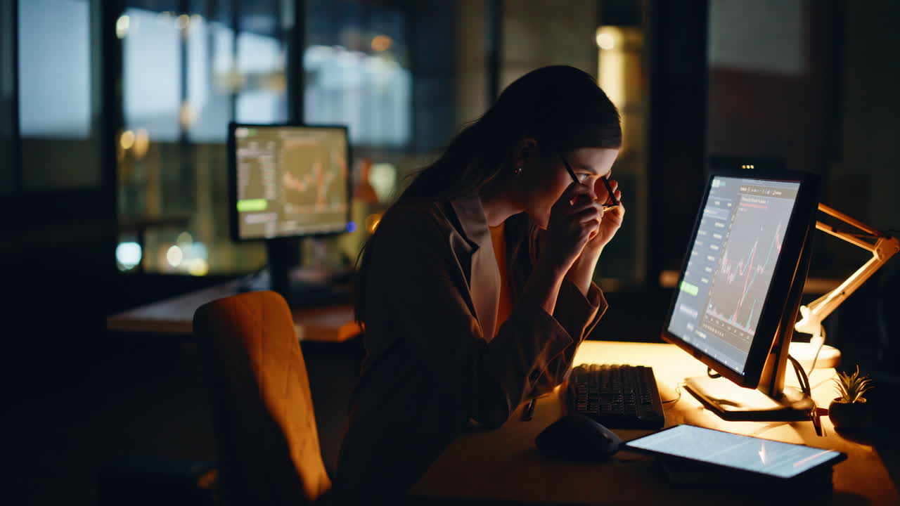 Overworked financier looking monitor working late in dark workplace closeup
