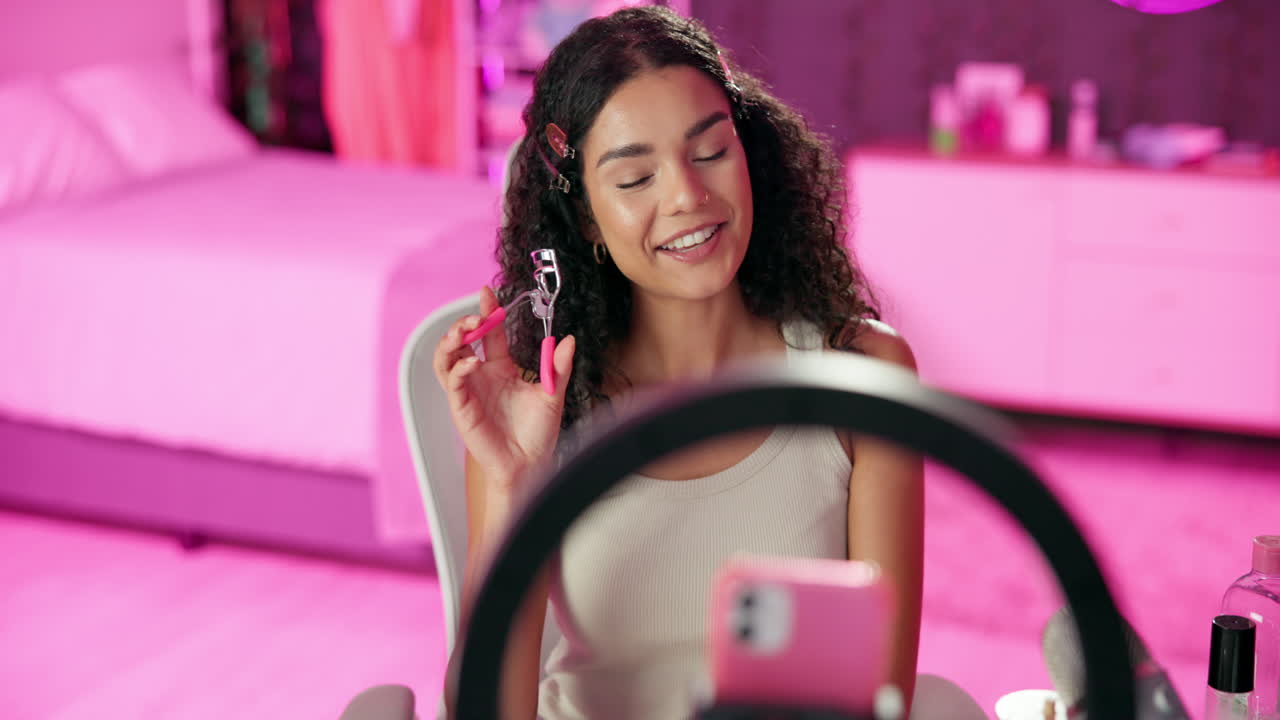 Woman applying makeup with eyelash curler