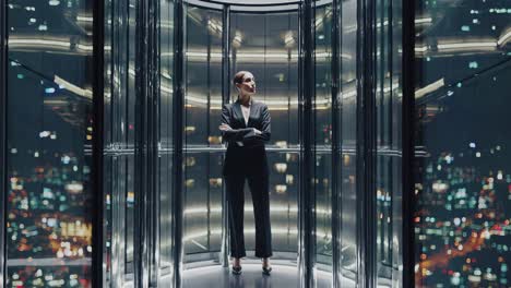confident businesswoman standing with arms crossed in panoramic glass elevator, enjoying the breathtaking view of illuminated cityscape at night, showcasing ambition, success, and urban lifestyle