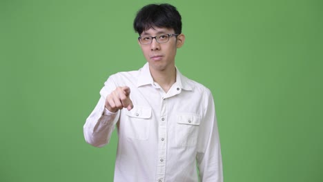 young asian businessman pointing to camera