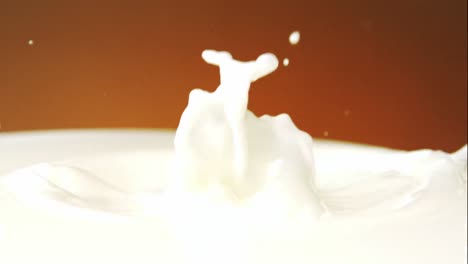 white chocolate falling into milk