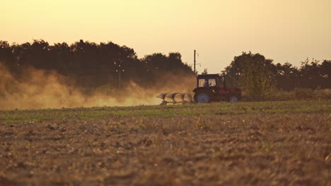 tractor working on the farm. tractor plowing fields, preparing land for sowing
