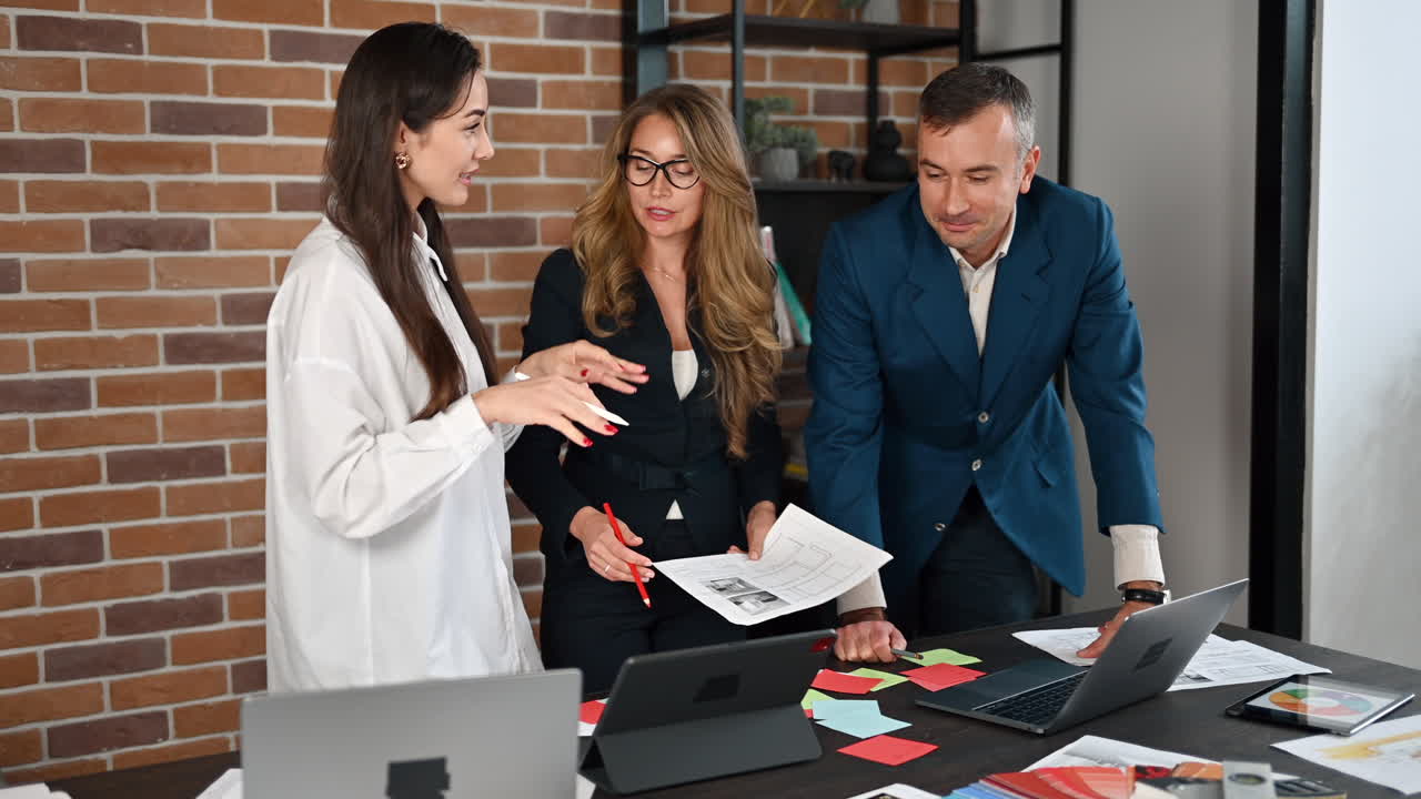 Three coworkers talking in an office