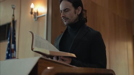 Christian-pastor,-preacher,-minister-in-church-reading-a-bible-at-church-pulpit