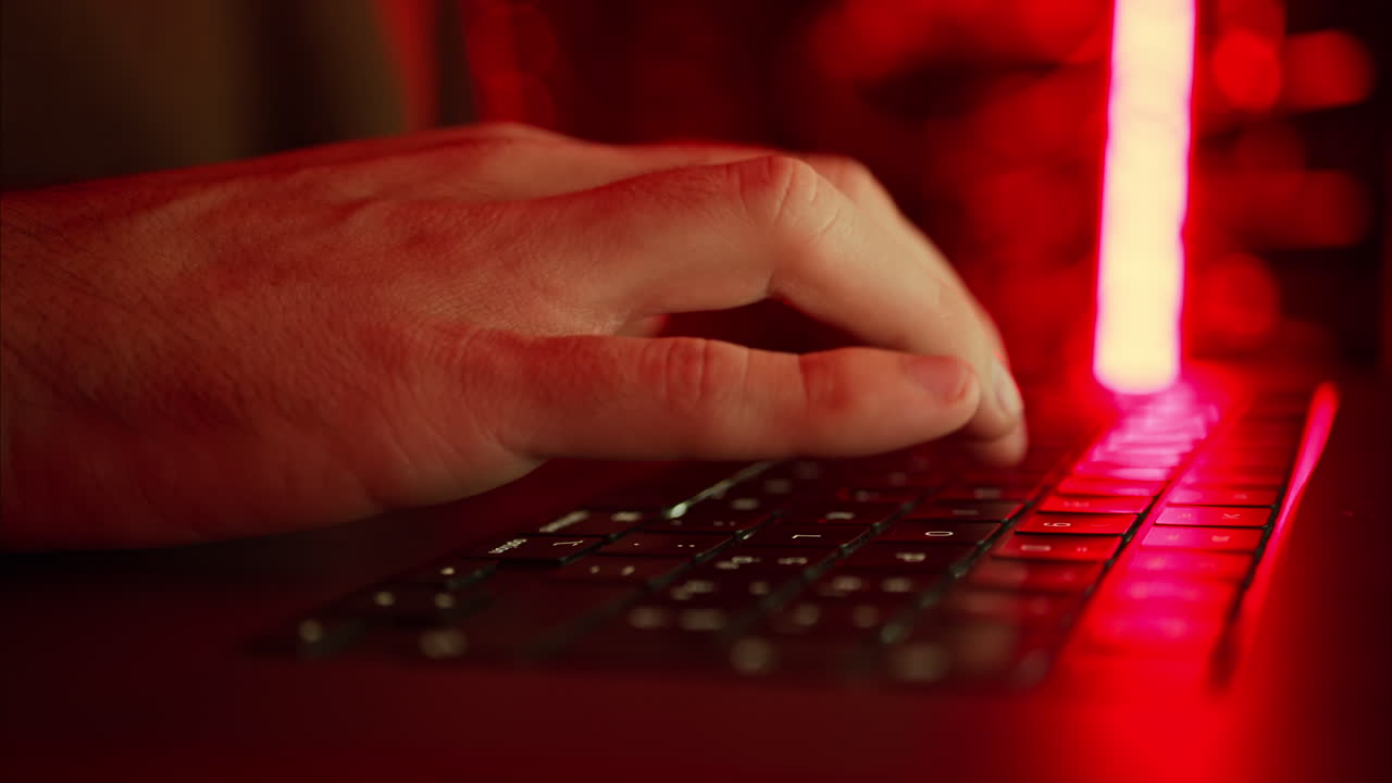 Close up of a man trying to fix an error on a computer in a server room
