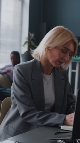 businesswoman working at her laptop in an office