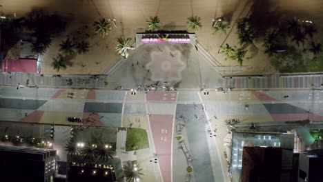 bird's eye aerial night shot of the main plaza in the center of tambaú with the city sign, a boardwalk along the beach, restaurants, and apartments in the capital city of joao pessoa, paraiba, brazil