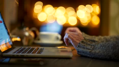 woman purchasing goods over the internet from her home, ordering home delivery using her credit card and laptop. e-commerce, typing. panoramic shot, 4k