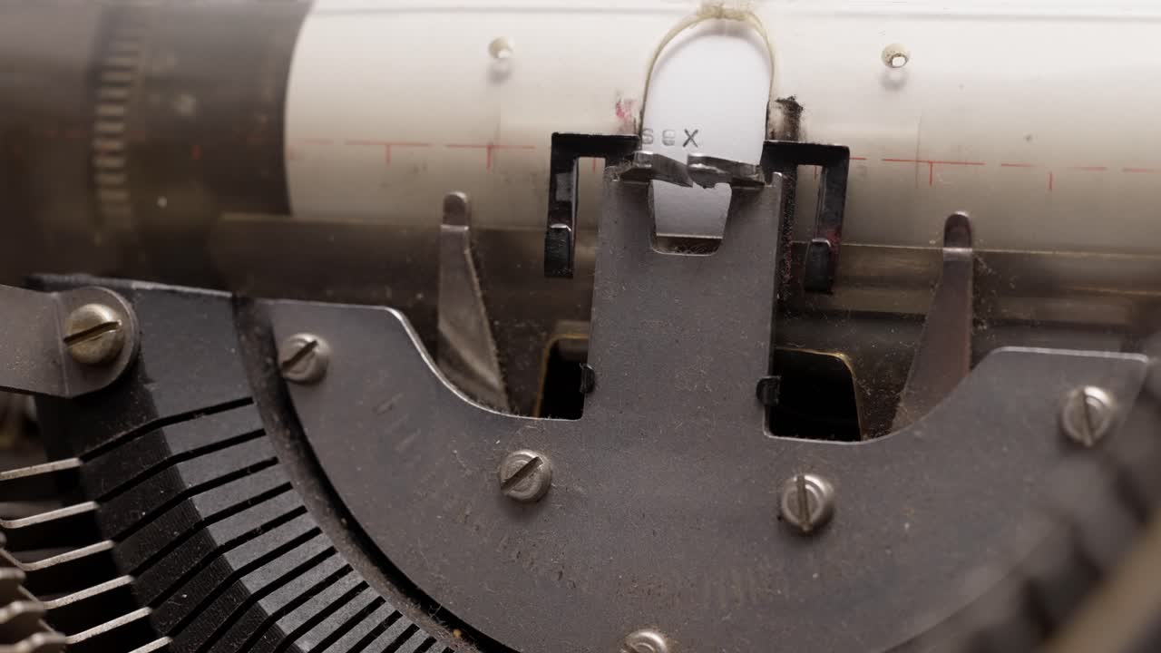 Close-up of a typewriter typing every single letter carefully on paper with mechanical precision