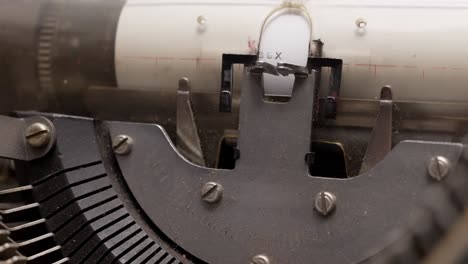 close-up of a typewriter typing every single letter carefully on paper with mechanical precision