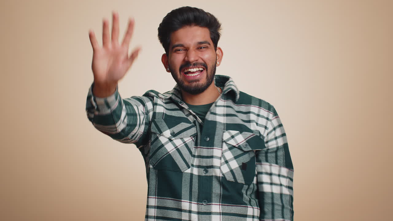 Man showing inviting gesture with hands ask to join beckoning to coming gesturing hello goodbye