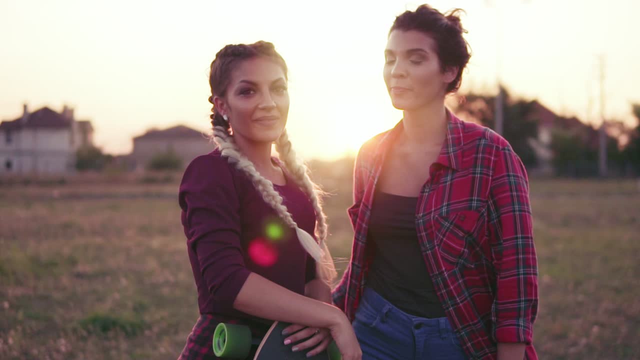 Two Best Friends Hugging Each Other And Looking In The Camera Smiling