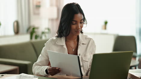 woman working from home with laptop and documents