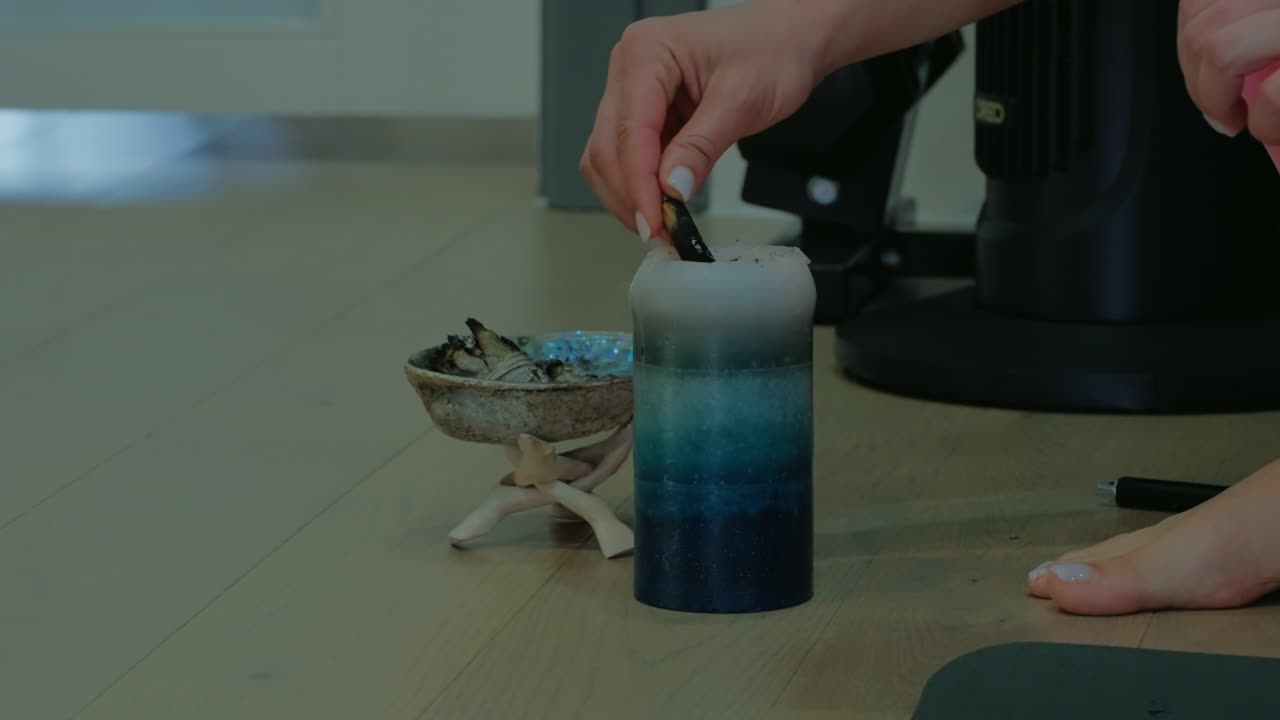 Fitness trianer doing calming smudging ritual using sage and a candle, practiced for energy clearing, mindfulness, and relaxation.