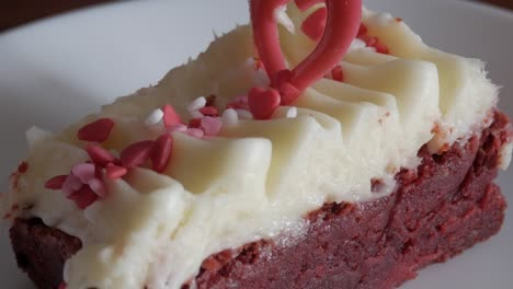 red velvet brownie with cream cheese frosting, heart sprinkles, valentine's mood