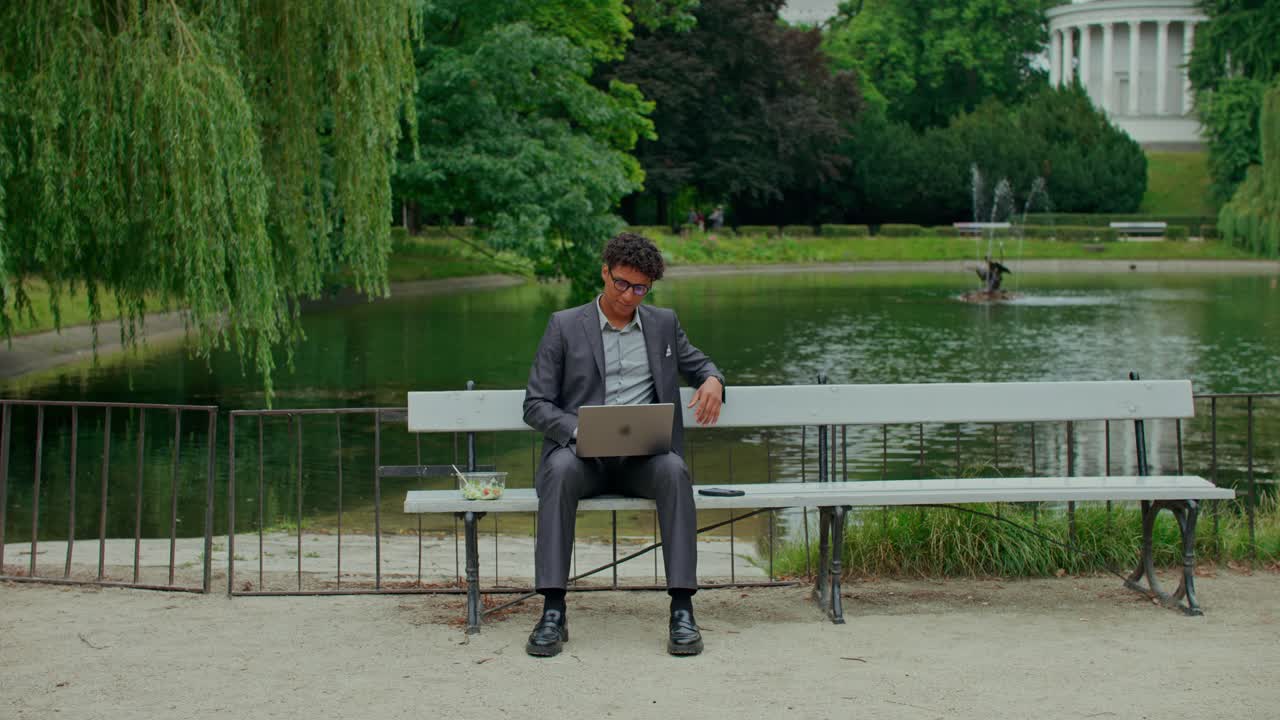 Man working on laptop in park