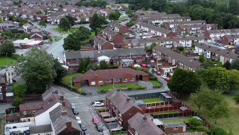 aerial view above british neighbourhood orbit right small town residential suburban property gardens and town streets