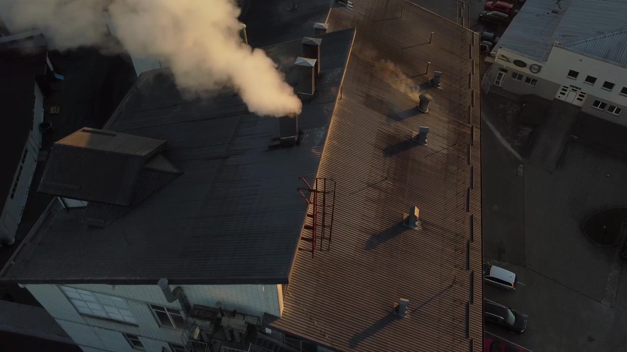 Aerial view of a drone flying over the beer production plant, several rows of tanks.