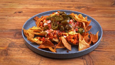 close-up shot of a delicious mound of mexican nachos piled high with tangy pico de gallo salsa, complemented by a scoop of velvety guacamole