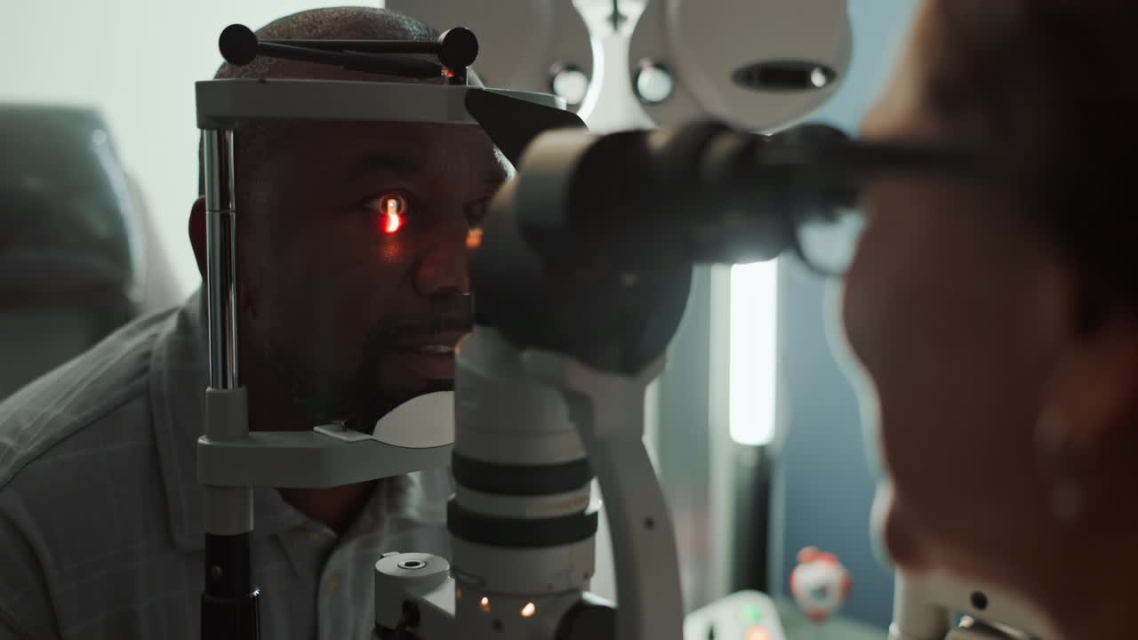 A man getting his eyes examined by a doctor.