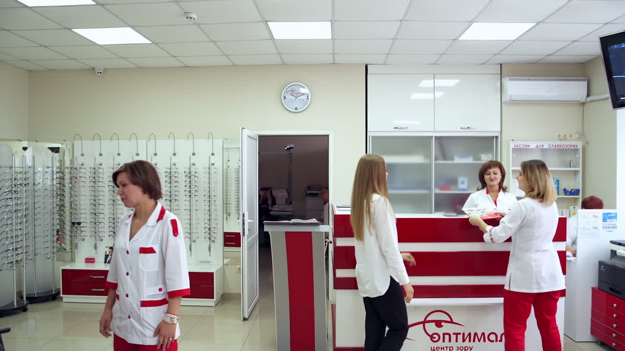 Reception Room At Clinic. Patients in waiting room in modern eye hospital