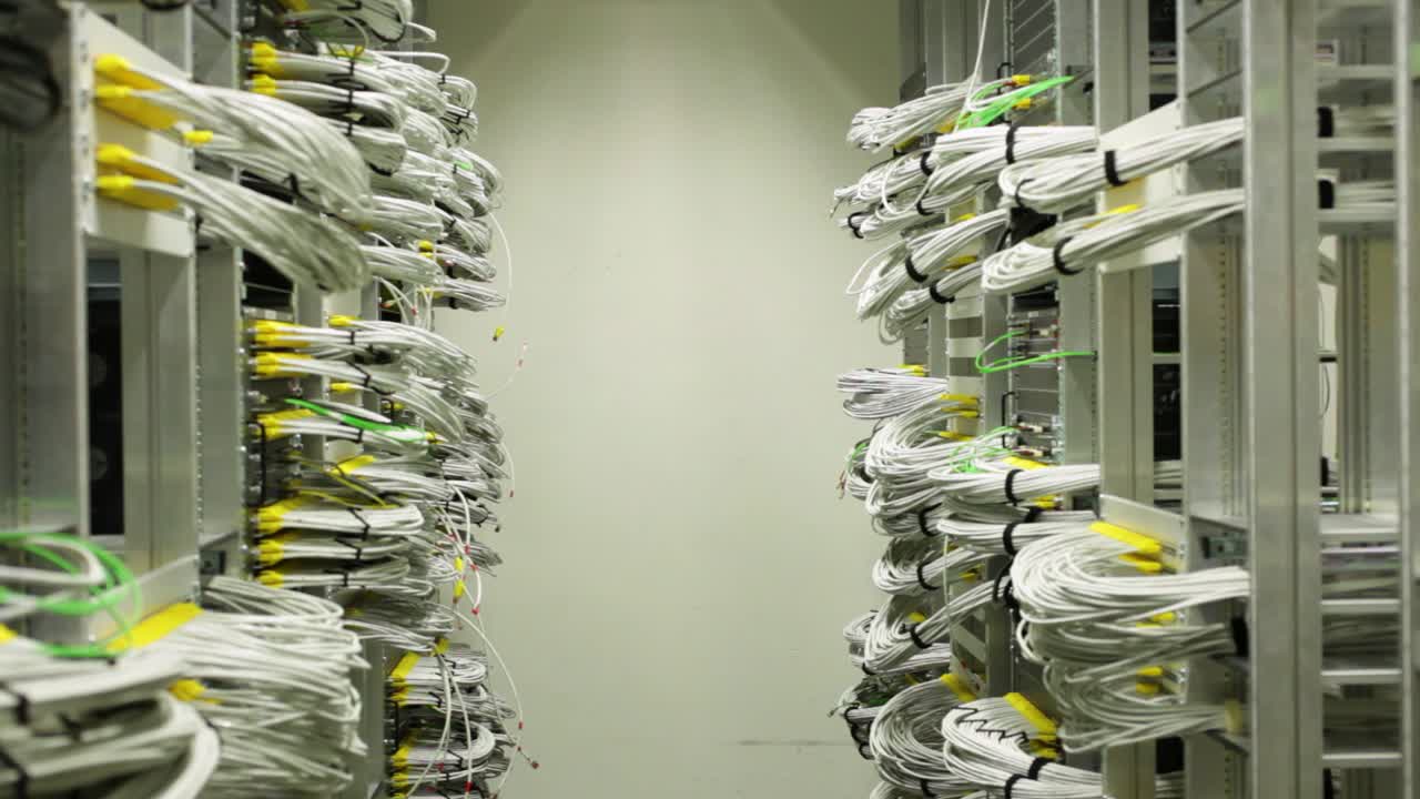 Establish server room with organized white and yellow cables, slide left