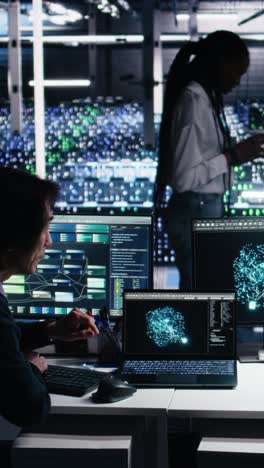 vertical video senior programmer and coworker in data center coding with generative ai