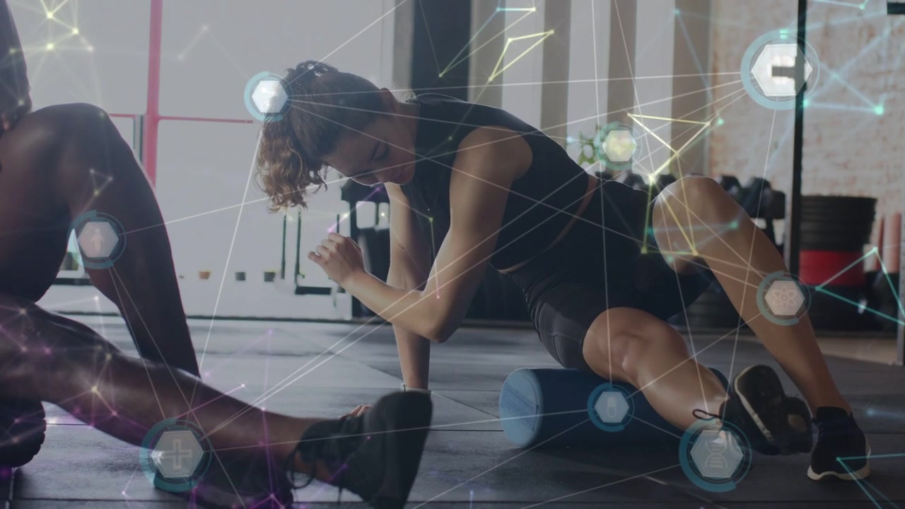 Woman doing postworkout recovery rolling blue roller on gym checking watch while hexgrid marking