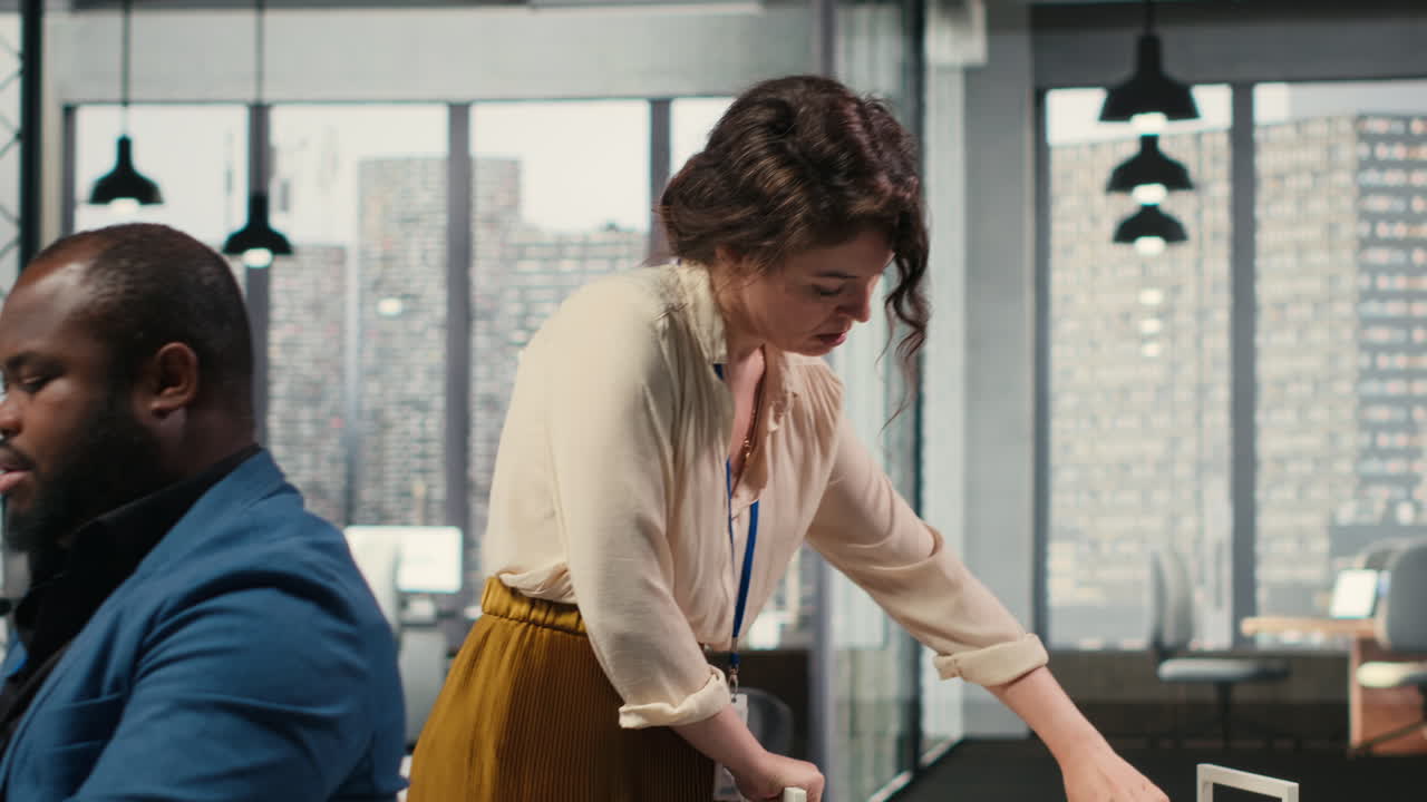 Vertical Video Workplace support employee moves a delivery cart stacked with folders