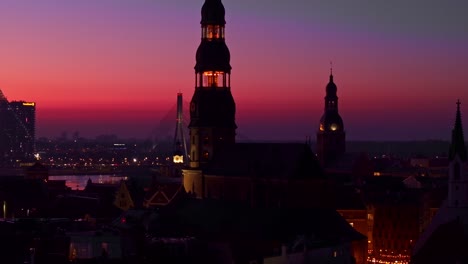 historic old town of riga glowing under a vibrant red violet sunset twilight sky