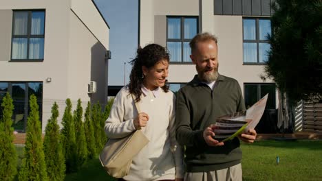 couple looking at a brochure for a new home