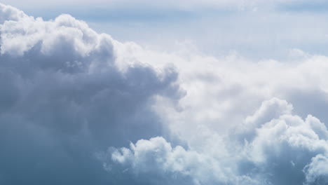 Rolling-puffy-clouds-moving-blue-sky-in-sunlight-drone-shot.-Majestic-nature.