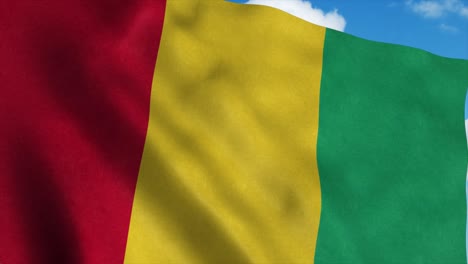 la bandera de guinea ondeando en el viento, el fondo del cielo azul. 4k