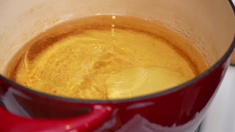 putting raw dough in hot oil to make indian bhatura bread - chana masala series