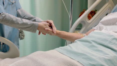 hospital nurse holding hand of old woman in bed comforting elderly patient hospitilized recovering from illness medical professional at bedside giving encouragement health care support