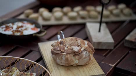 sliced mushrooms being sautéed in a pan with visible steam during outdoor meal preparation