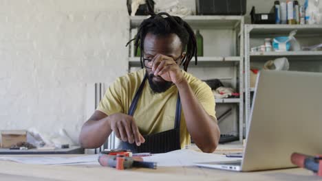 Thoughtful-carpenter-working-at-table-4k