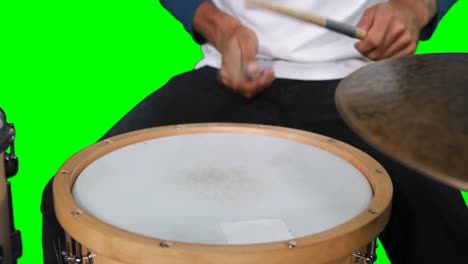 Mid-section-of-drumer-playing-drum