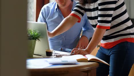 couple discussing over laptop in kitchen at home 4k